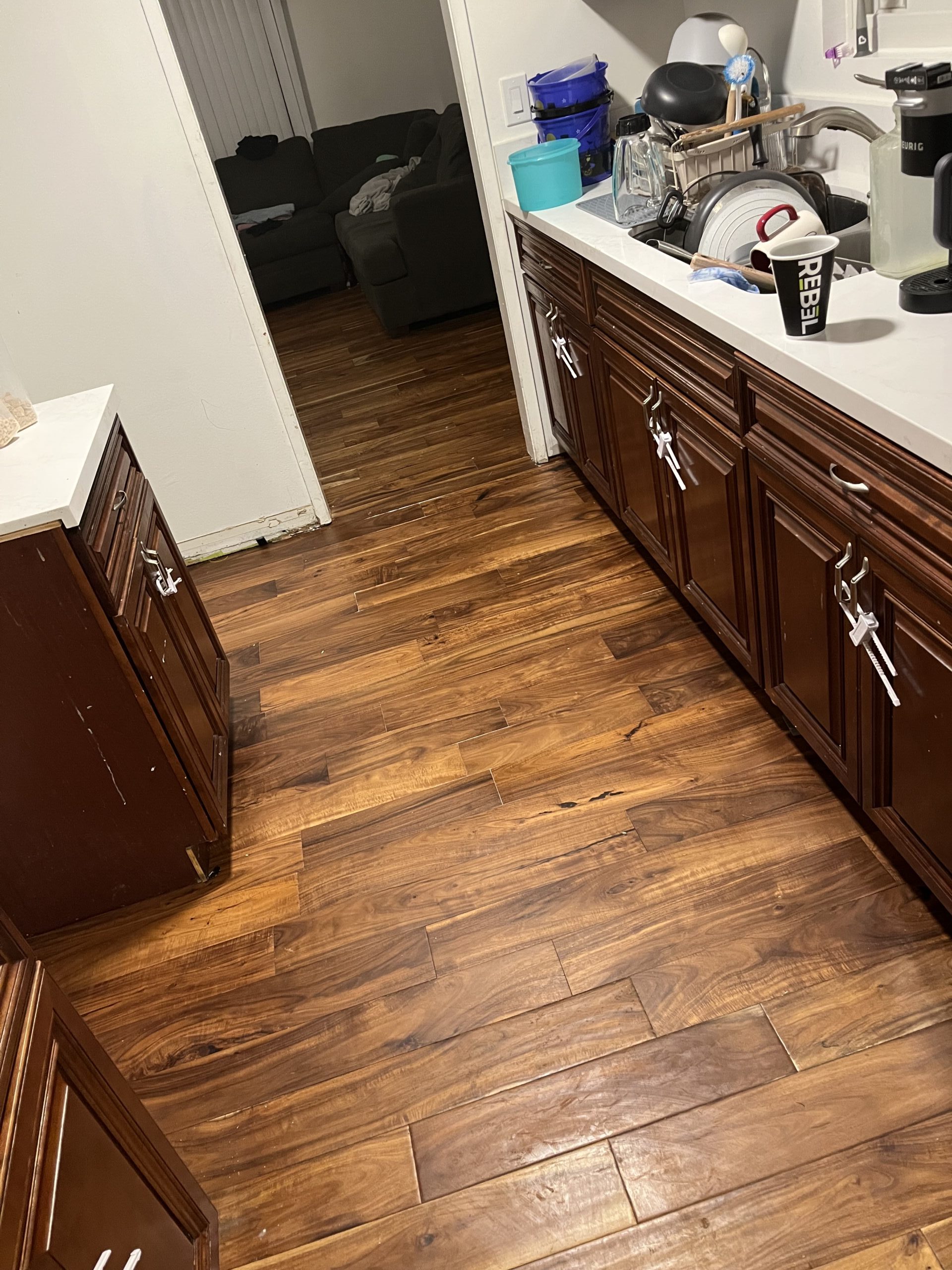 Kitchen floor after repair with matching hardwood planks fully installed