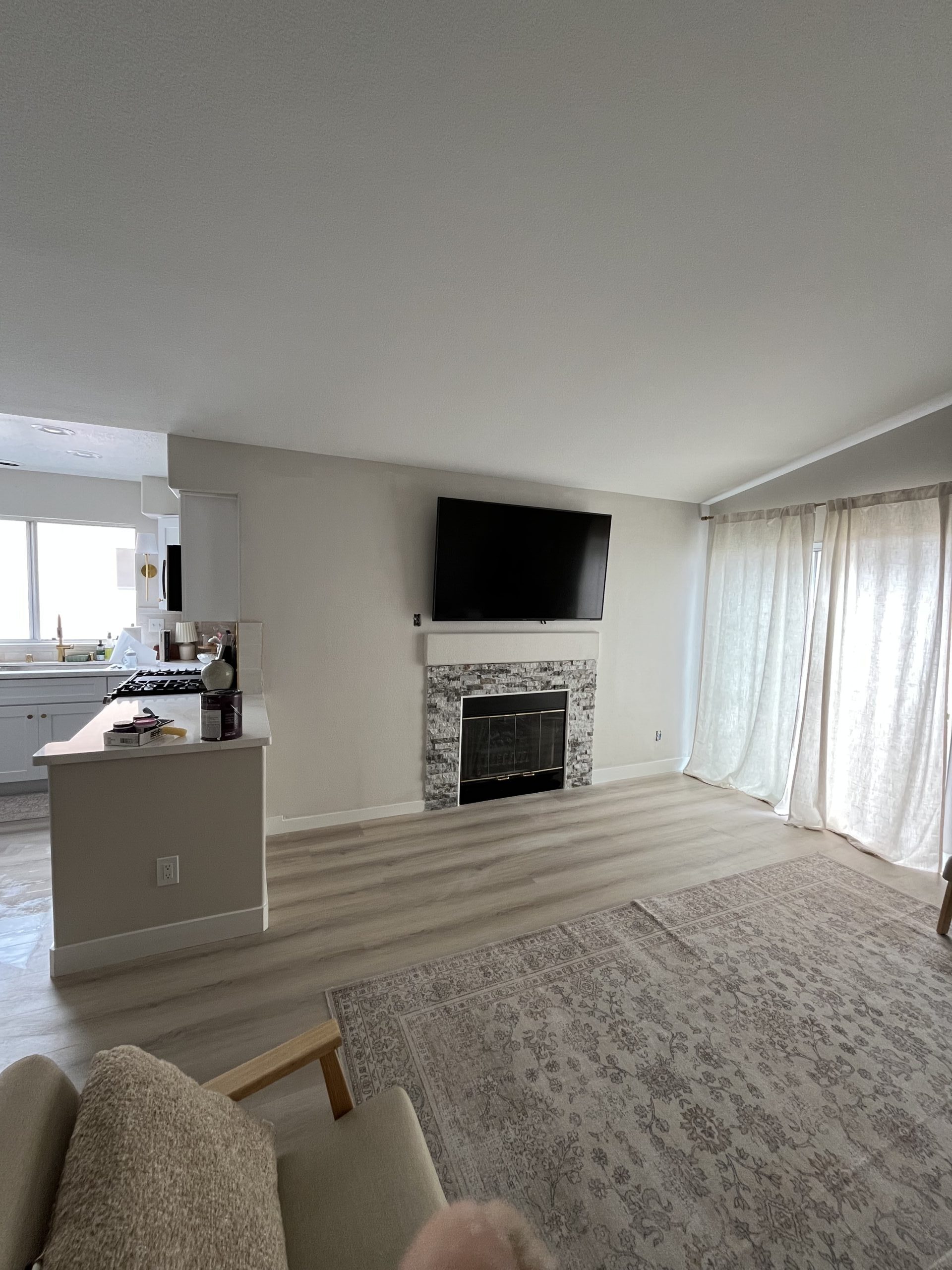 Freshly painted living room with a wall-mounted TV above the fireplace